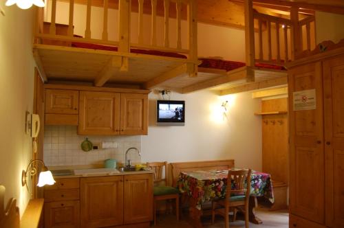 a kitchen with wooden cabinets and a table and a sink at Casa Elena in Rabbi