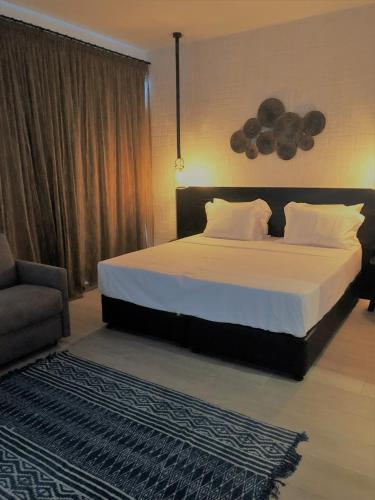 a bedroom with a large bed and a couch at Abacus Suites in Ayia Napa