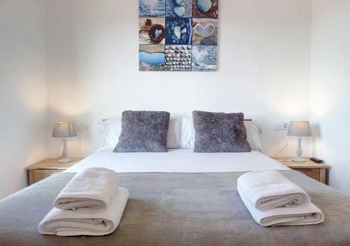 een slaapkamer met een bed met twee handdoeken erop bij Empordà Residencial in L'Estartit