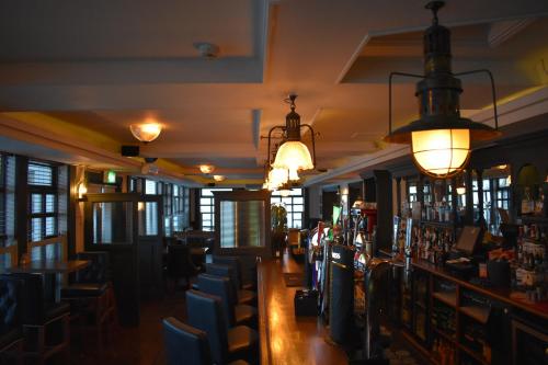 a bar in a restaurant with chairs and lights at Kildare House Hotel in Kildare