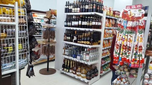 a store filled with lots of bottles of alcohol at Apartment Zhemchuzhina Ureki in Ureki