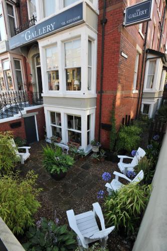 a group of white chairs in front of a building at The Gallery in Blackpool