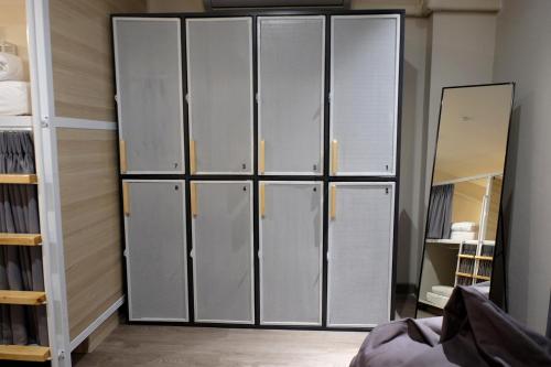 a group of lockers in a room with a mirror at Siam Mansion - SHA in Hat Yai