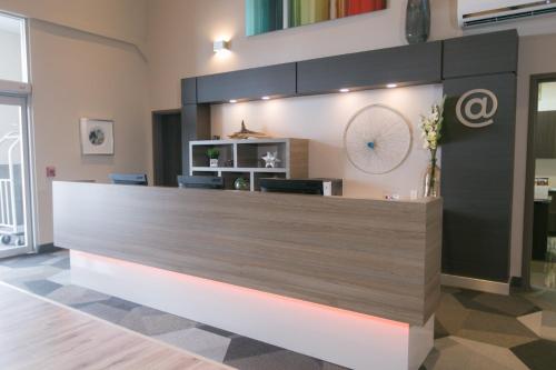 a lobby with a reception desk in a building at Best Western Plus Dartmouth Hotel & Suites in Halifax