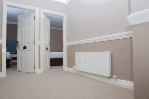 a room with a white door and a bedroom at McMunns of Ballybunion in Ballybunion