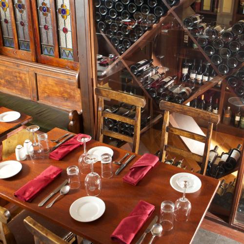 a wooden table with red napkins and wine bottles at McMunns of Ballybunion in Ballybunion