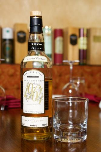 a bottle of whiskey and a glass on a table at McMunns of Ballybunion in Ballybunion