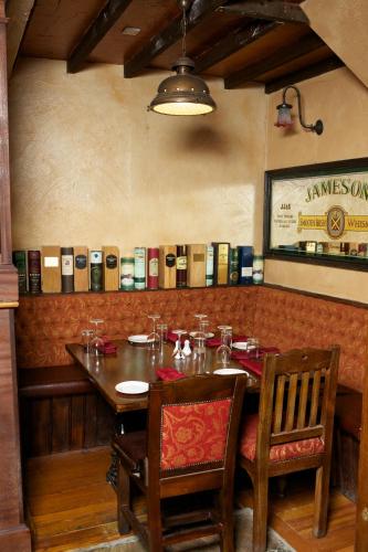 a dining room with a table and chairs and books at McMunns of Ballybunion in Ballybunion