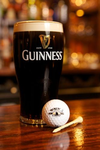 a pint of beer and a baseball on a table at McMunns of Ballybunion in Ballybunion