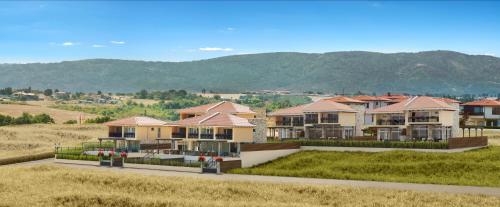 a row of houses with mountains in the background at Coral Luxury Villas in Lozenets