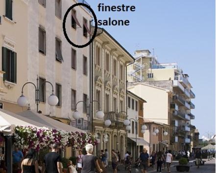 a group of people walking down a city street at Via Roma 44 in Follonica