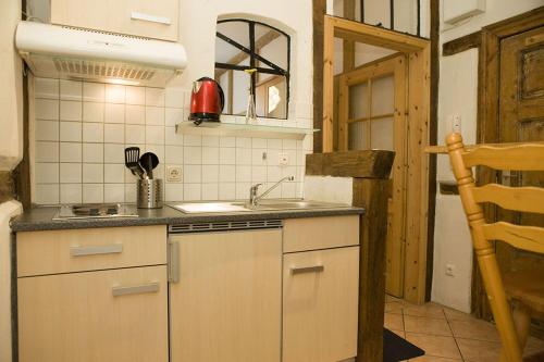 a small kitchen with a sink and a stove at Ferienwohnungen und Ferienhäuser Gohr in Stralsund