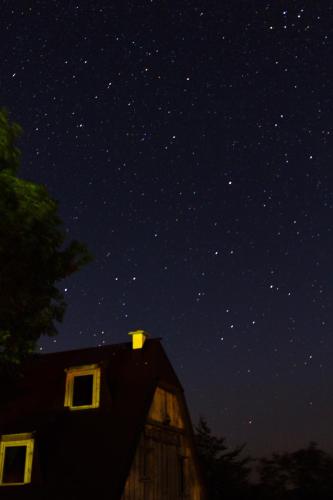 a barn under a starry sky at night at Maple village in Žabljak