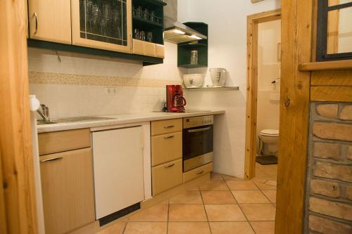 a small kitchen with a sink and a stove at Ferienwohnungen und Ferienhäuser Gohr in Stralsund