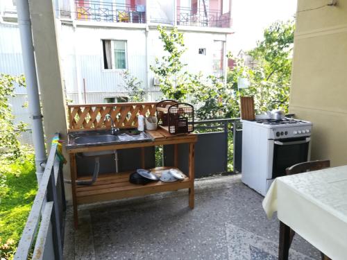 a kitchen with a sink and a stove on a balcony at Guest house of Givi in K'obulet'i