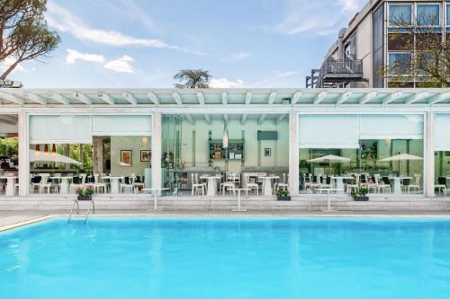 a swimming pool in front of a building at Italiana Hotels Florence in Florence