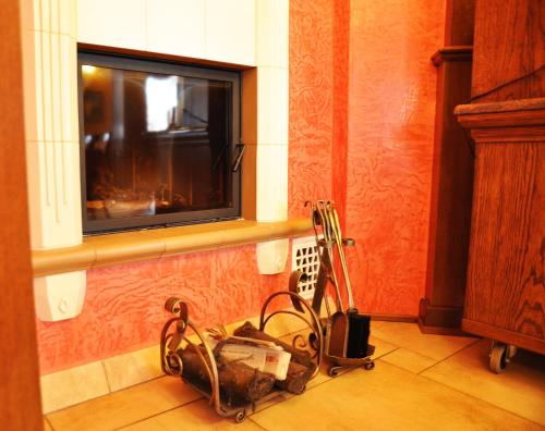 a kitchen with a tv and a vacuum in a room at Willa Koba in Ustroń
