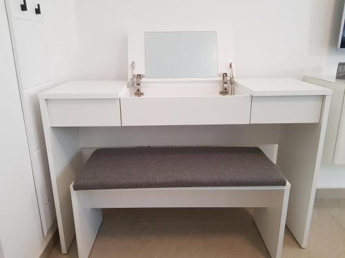 a white bathroom sink with a bench under it at eVita Fazana Premium Studio Apartments in Fažana