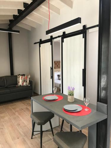 a dining room table with two plates and wine glasses at B. U. Luxury Apartments in Asprovalta