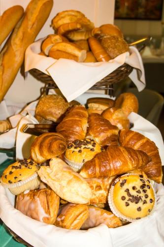 a plate of various types of bread and pastries at Dorint Parkhotel Meißen in Meißen