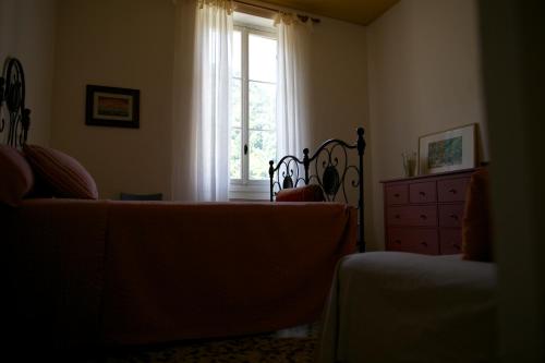 a living room with a couch and a dresser and a window at Le Gemme di Pigna in Pigna