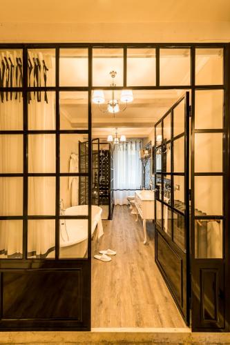 a room with glass doors and a room with a table at La Vite 2.0 apartments in Desenzano del Garda