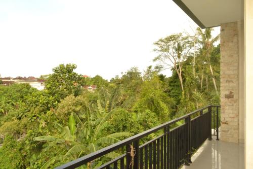 a balcony of a house with trees and bushes at Villa Shanti Bali in Sempidi