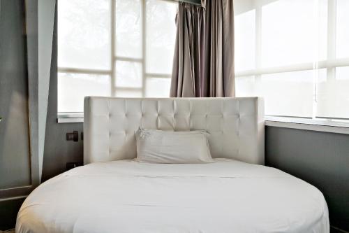 a white bed in a room with a window at Italiana Hotels Florence in Florence