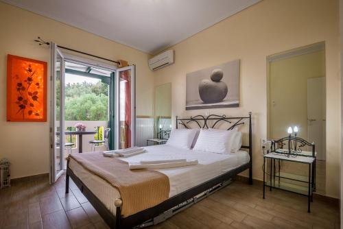 a bedroom with a large bed and a window at Ionian Villas in Agios Nikitas
