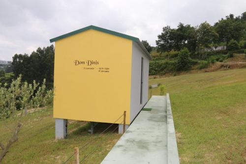 a yellow building with the words donuts written on it at Quinta da Costa in Lixa