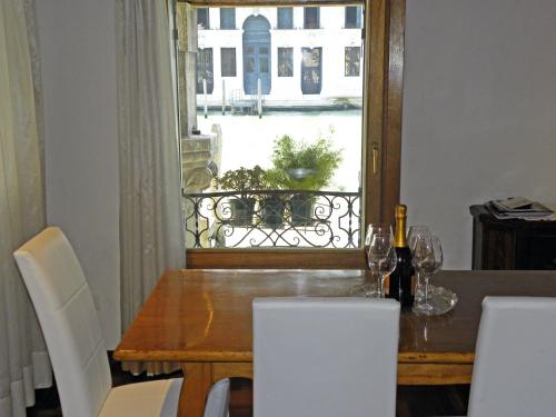 a dining room table with a view of a window at La Felice Canal Grande in Venice