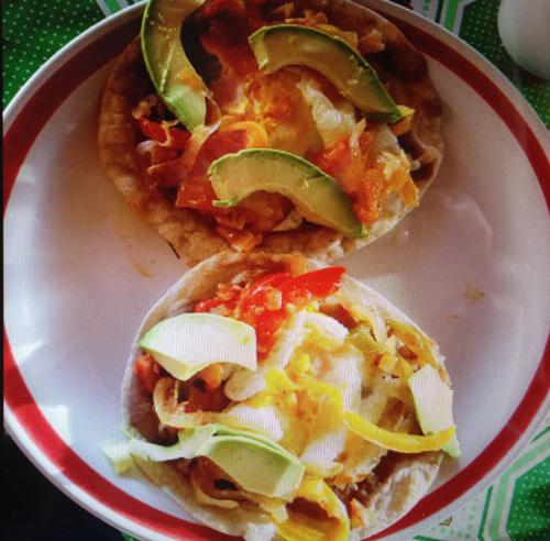 two small pizzas sitting on a white plate at Xcalak Caribe Lodge in Xcalak