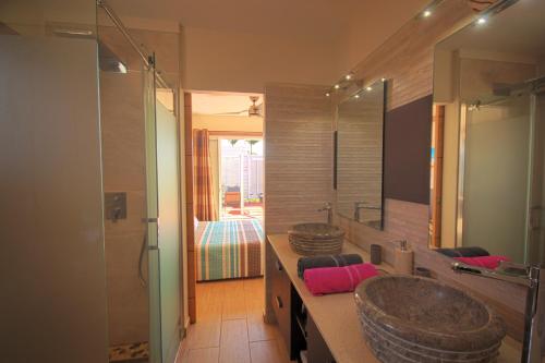 a bathroom with a large sink and a mirror at Villa with private pool SF69 in Saint-François