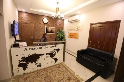 a map of the world sign in a room at Safari Club 4 in Rawalpindi