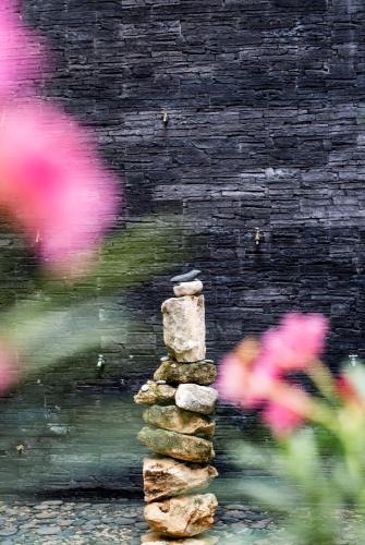a stack of rocks in front of a stone wall at Hotel 52 Playa del Carmen in Playa del Carmen