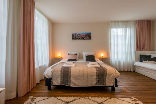 a bedroom with a large bed and a couch at Friday Gent, Exclusive Charming Guesthouse in Ghent