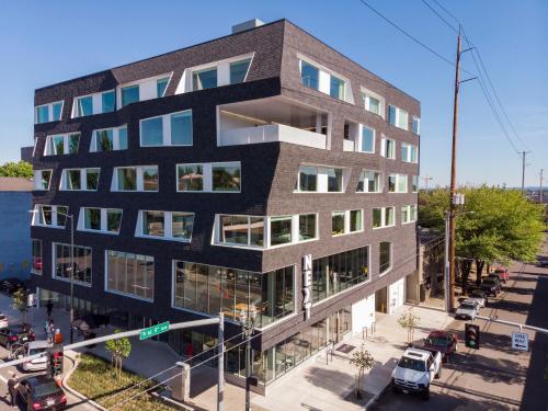 a building on a street with cars parked in front of it at Jupiter NEXT in Portland