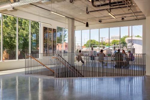 a lobby with a metal gate with people walking around at Jupiter NEXT in Portland
