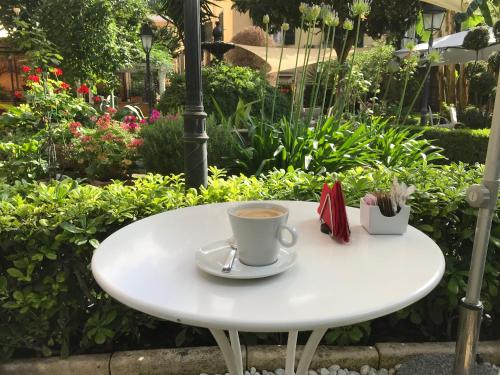 ein weißer Tisch mit einer Tasse Kaffee darauf in der Unterkunft Villa Matissa in Rom