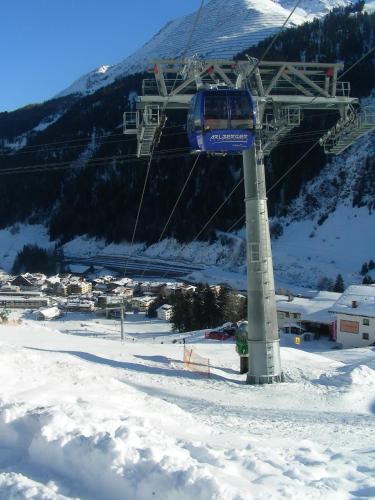 a ski lift on a ski slope in the snow at Appartements Tschol Martin in Sankt Anton am Arlberg