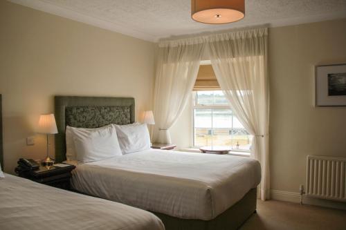 Кровать или кровати в номере Walter Raleigh Hotel
