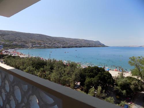 a view of a beach from a balcony at Apartments Galeb Pag - Beach in Pag