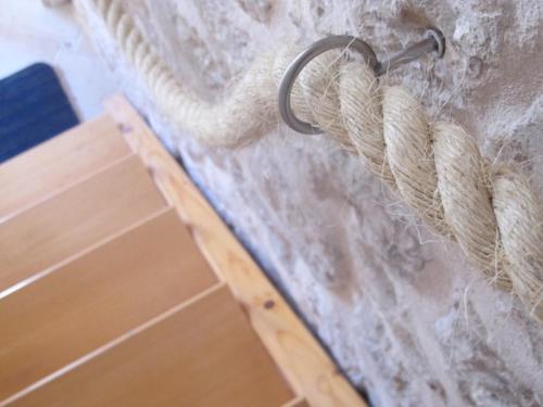 a rope hanging from a wall next to a door at Takoma Hvar in Hvar