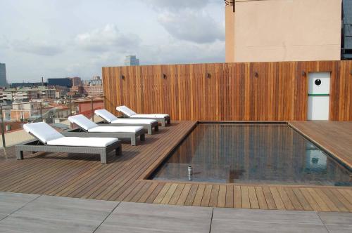 a row of chairs sitting on top of a building at Hotel Urpí in Sabadell
