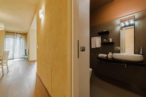 a bathroom with a sink and a toilet in a room at Maison La Scala Luxury solution Lazise Center in Lazise