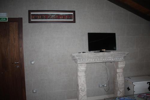 a tv sitting on top of a stone wall at Apartamentos Numancia in Garray