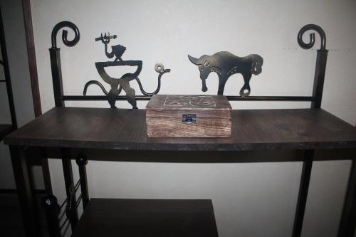 a table with a cat and figurines on top of it at Apartamentos Numancia in Garray