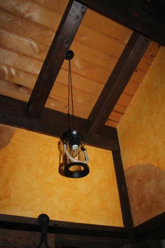 a chandelier hanging from the ceiling of a room at Apartamentos Numancia in Garray
