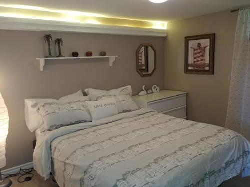 a bedroom with a large bed with white sheets at Bradford Vacation in Bradford