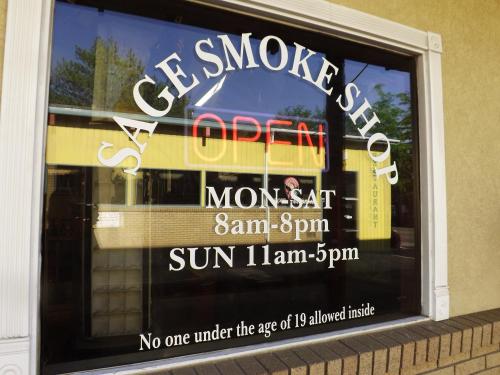 a window of a store with a sign in it at Sage Motel in Vernal
